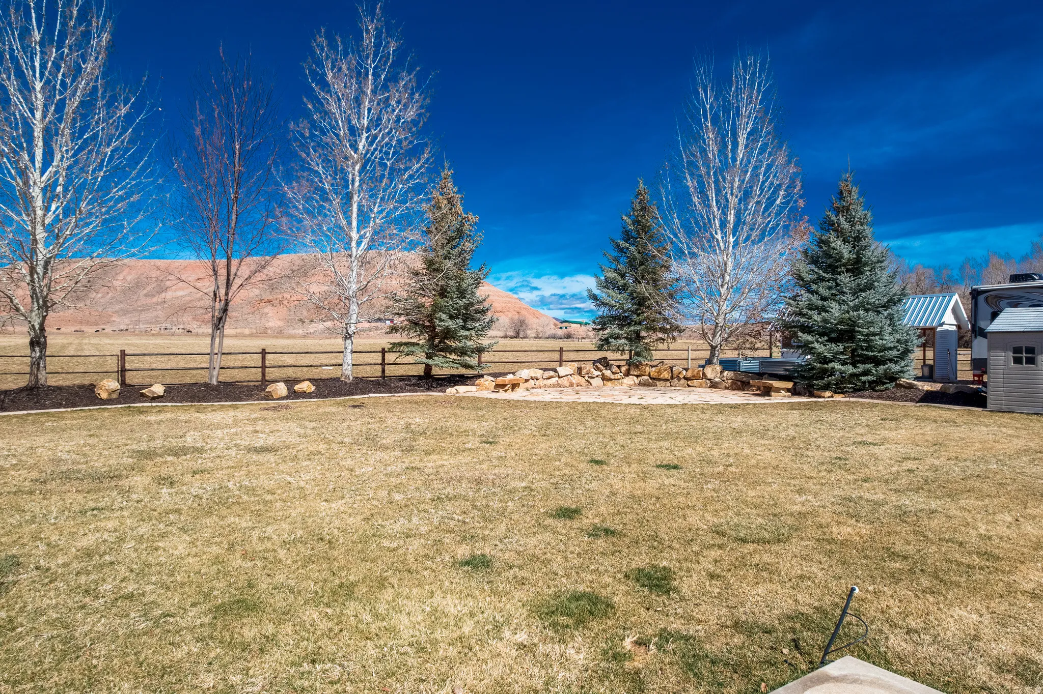 Fenced backyard featuring a mountain view