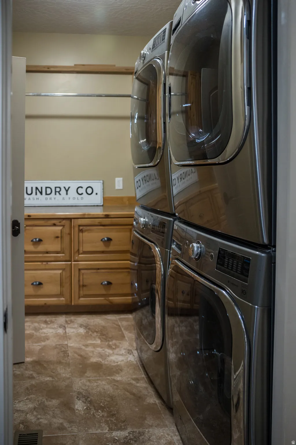 Laundry area featuring stacked washer / dryer