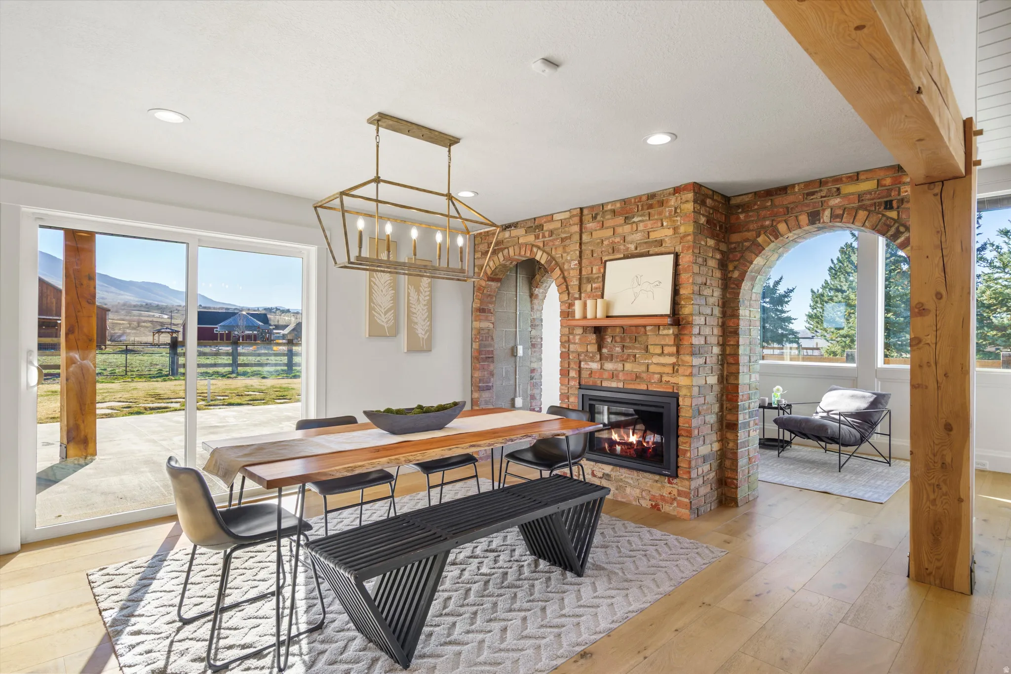 Dining room with light wood-type flooring, plenty of natural light, a fireplace, and a mountain view