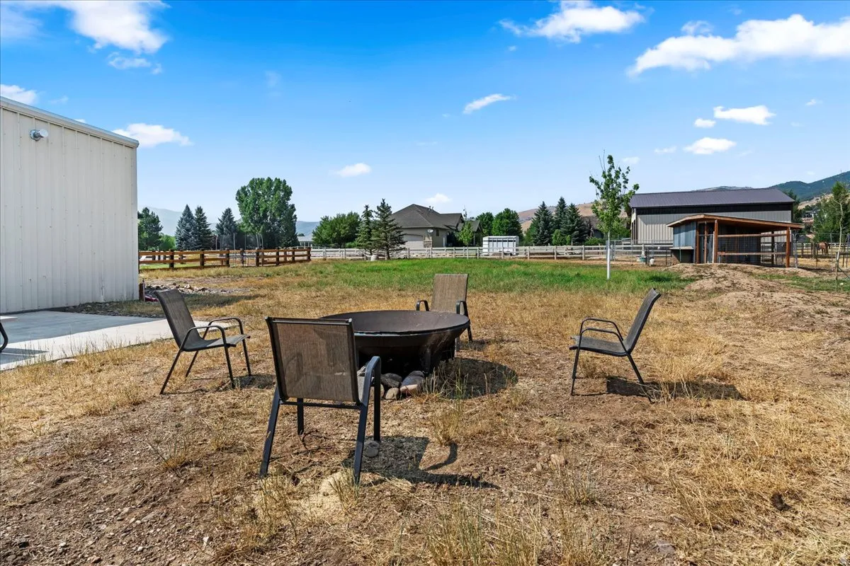 View of yard with a patio area, an outbuilding, and a mountain view