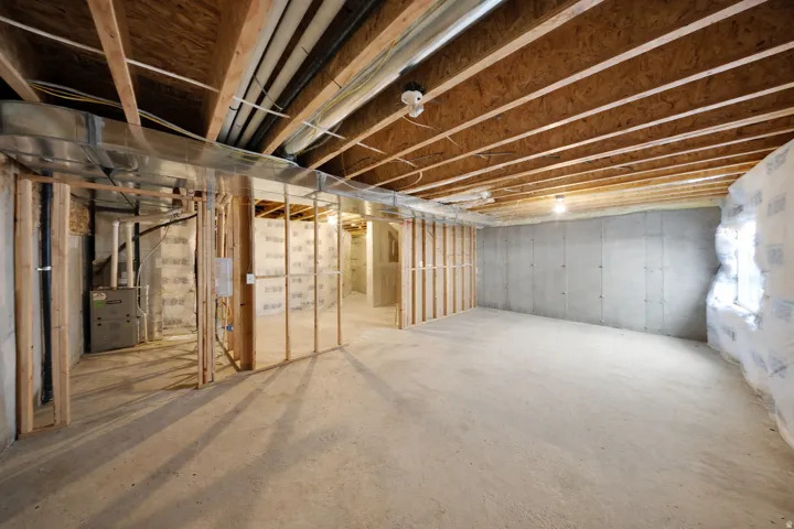 Unfinished below grade area with heating unit