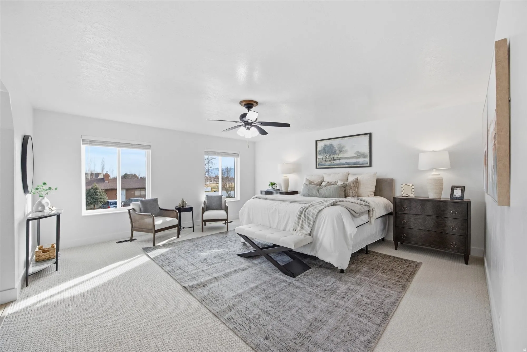 Bedroom with light colored carpet and ceiling fan