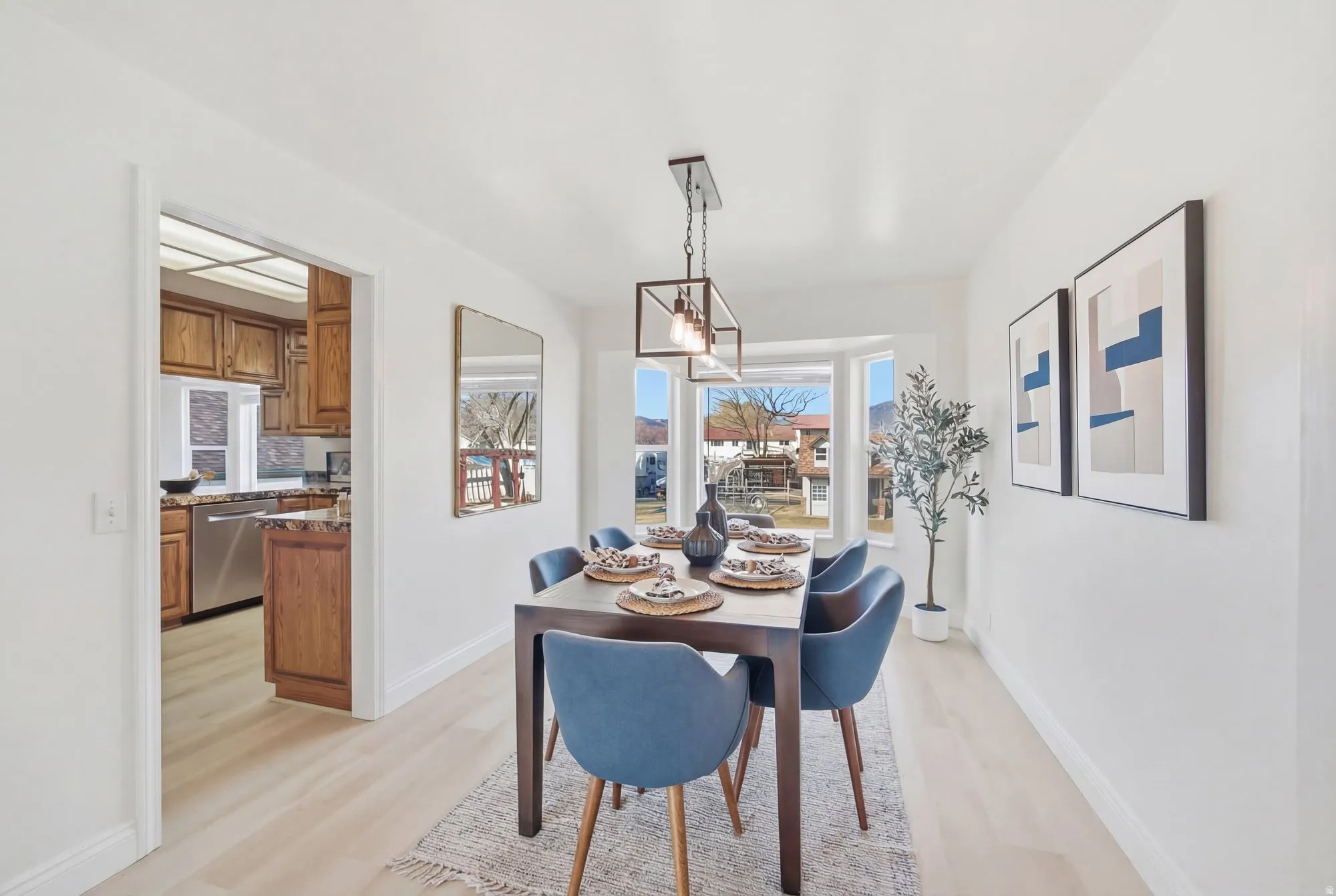Dining area featuring light LVP flooring and baseboards