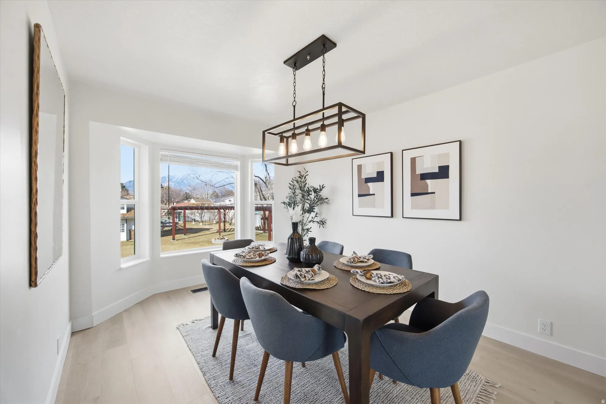 Dining space with light LVP flooring and baseboards