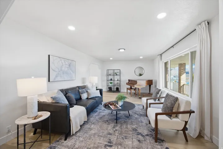 Living room featuring light wood-style flooring and recessed lighting