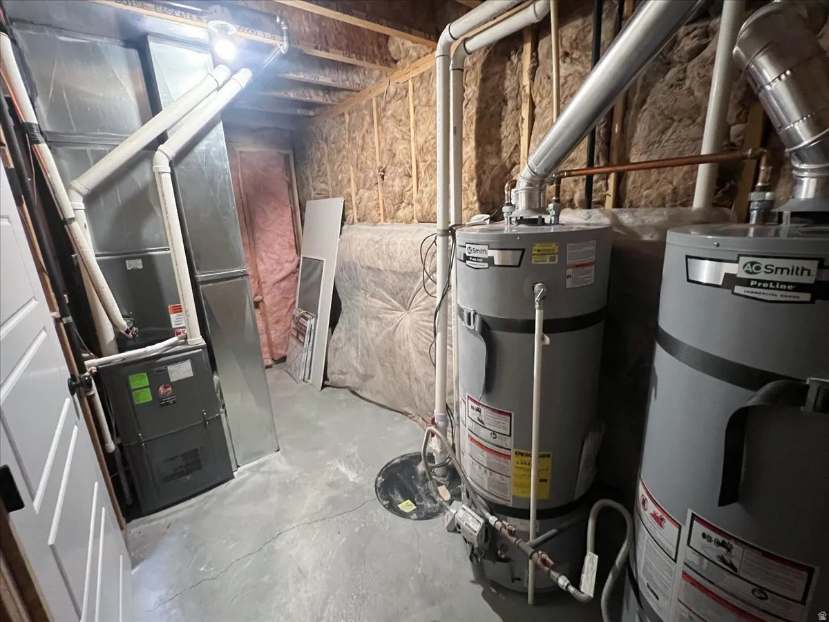 Utility room with strapped water heater and heating unit