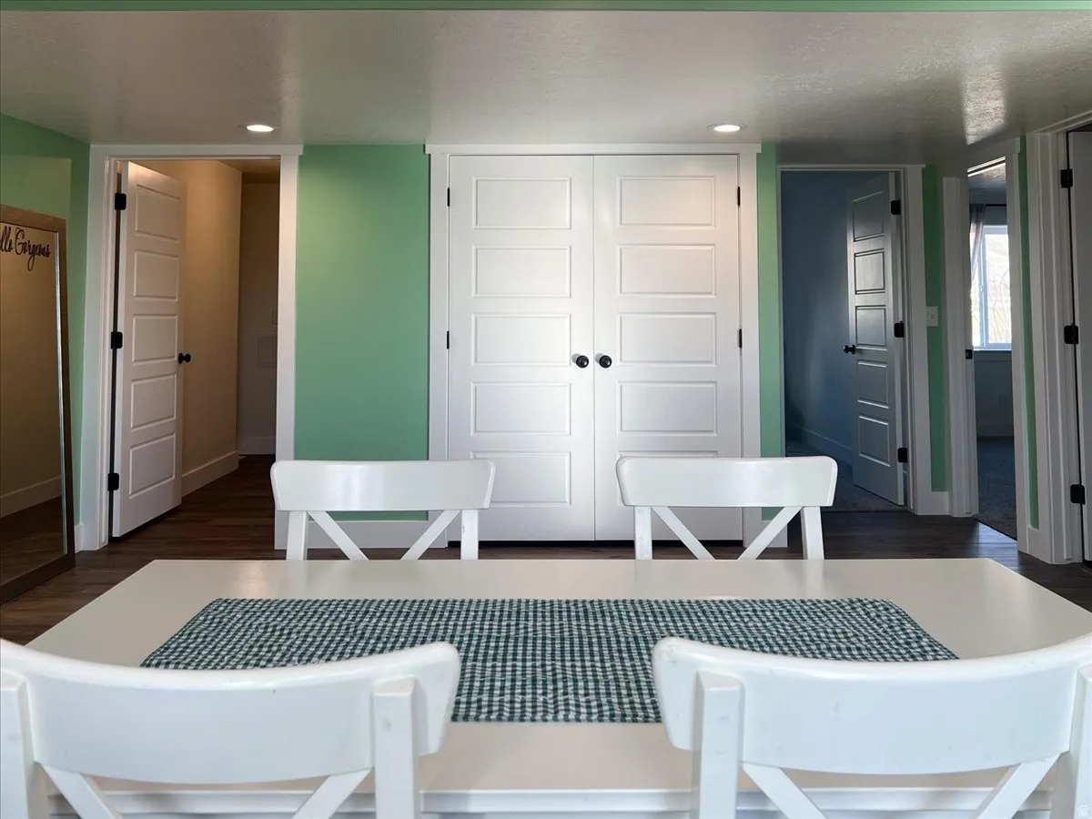 Dining area featuring dark wood-type flooring and recessed lighting