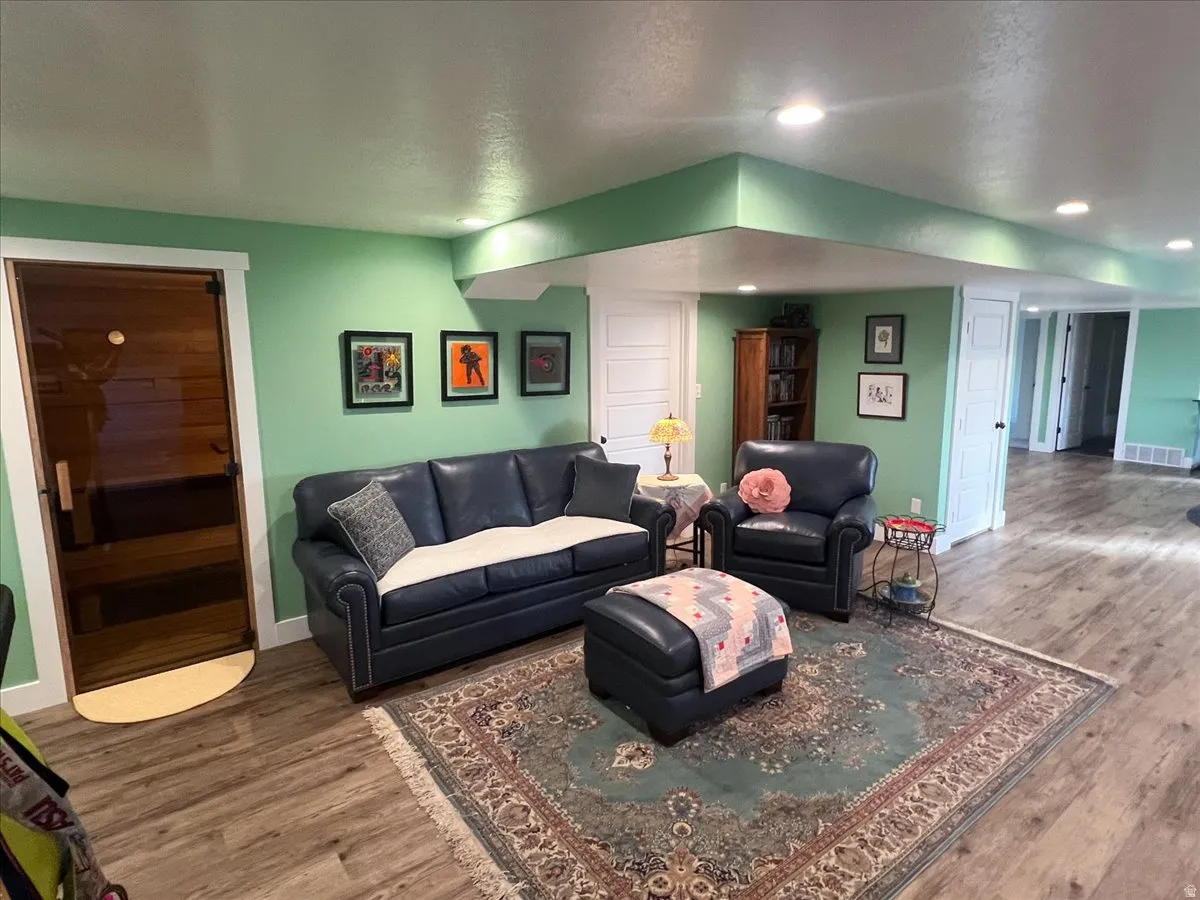 Living area featuring a relaxing sauna, wood finished floors, a textured ceiling, and recessed lighting