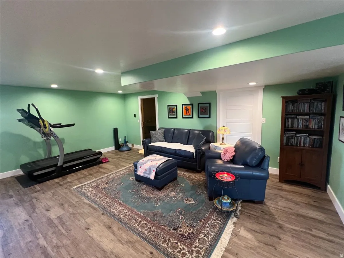Living room with wood finished floors and recessed lighting