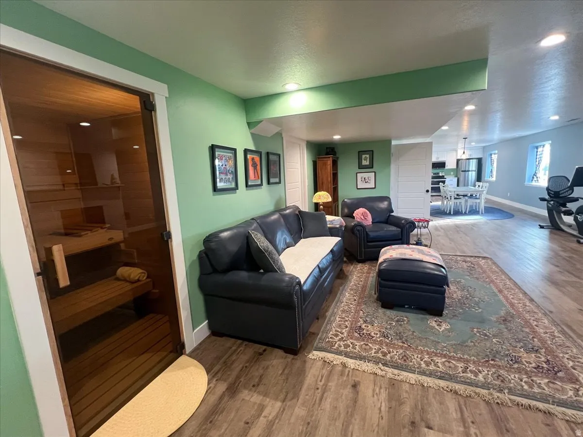 Living room with wood finished floors, a sauna, and recessed lighting