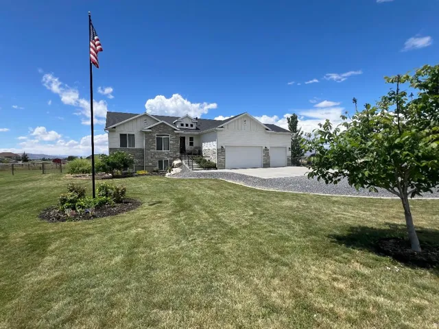 Expansive front yard with a large green lawn