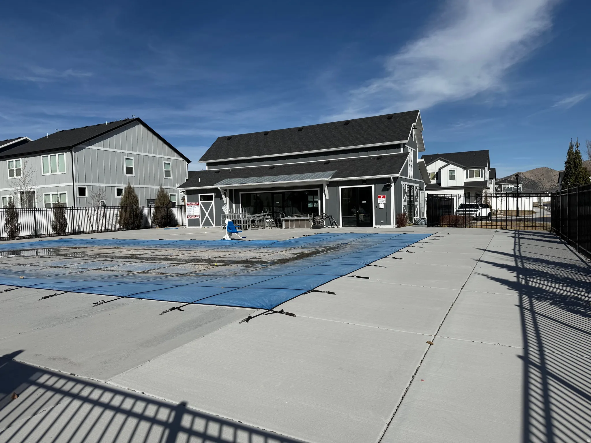Community pool with a residential view