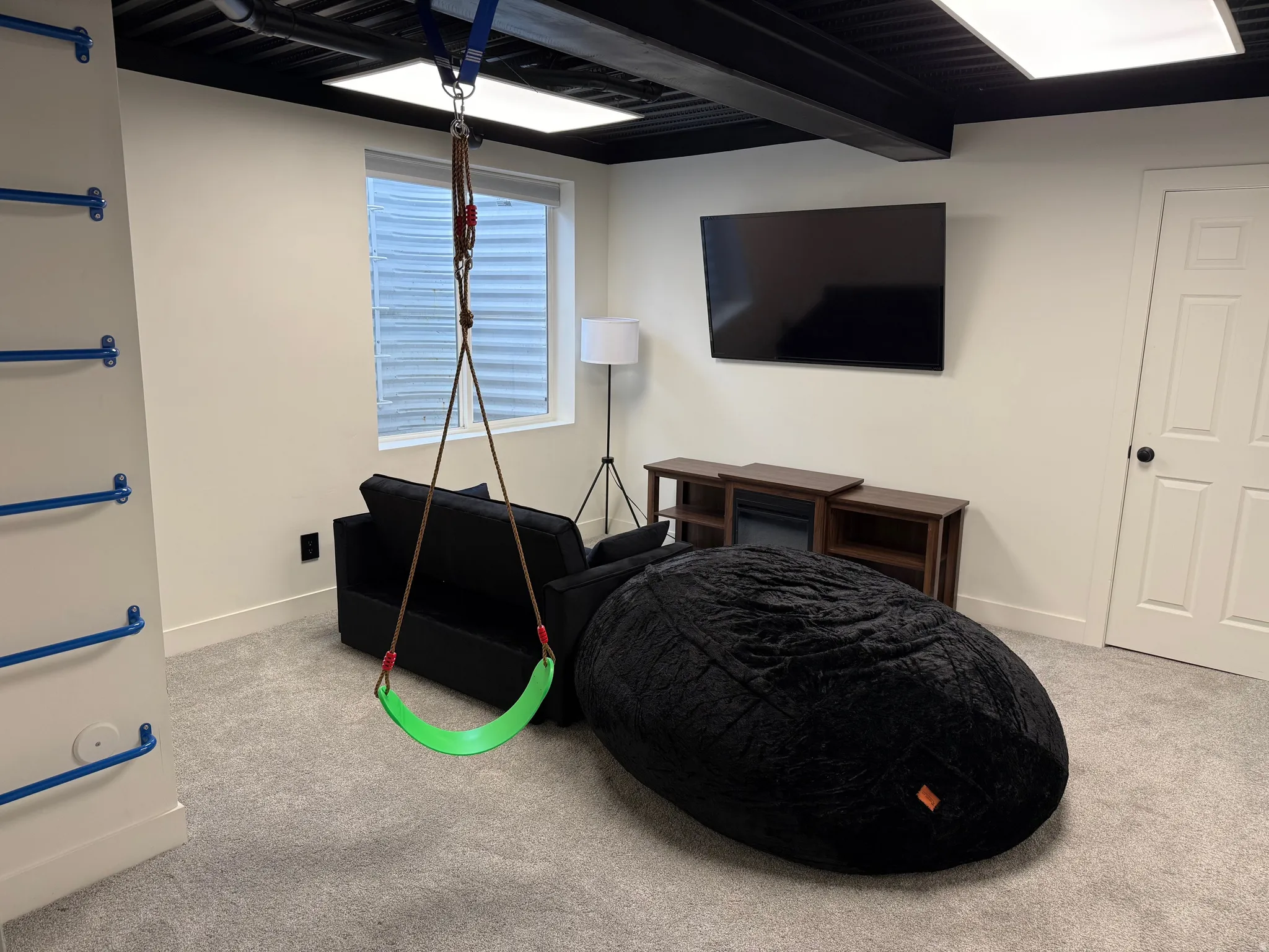 Bedroom/Rec room with light colored carpet and beam ceiling