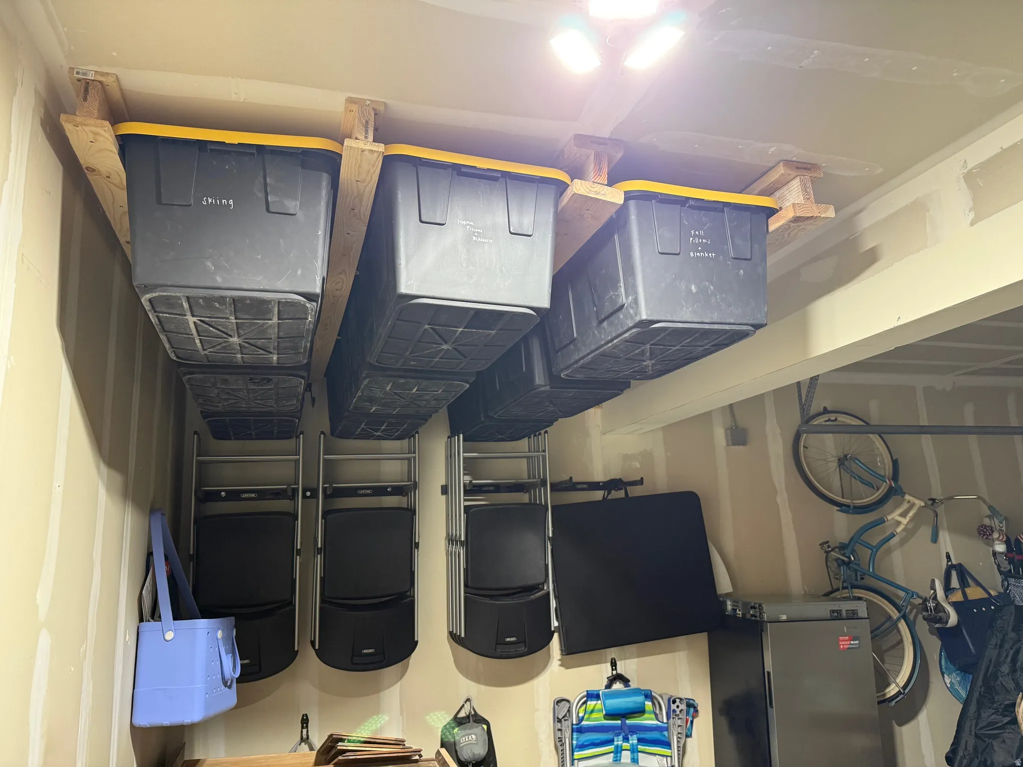 View of storage tracks designed to store totes. Totes not included.