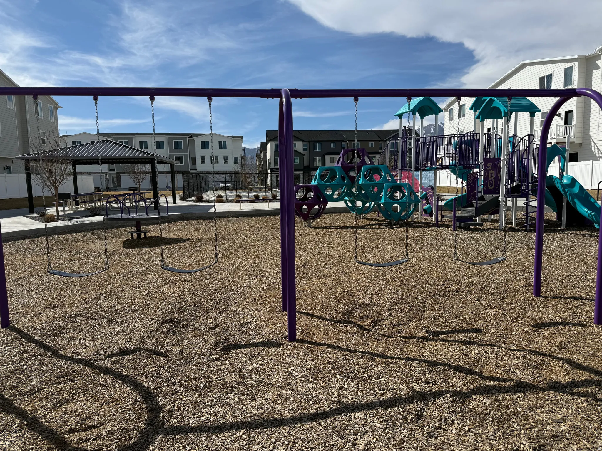 Community playground with a patio area, a gazebo, and a residential view