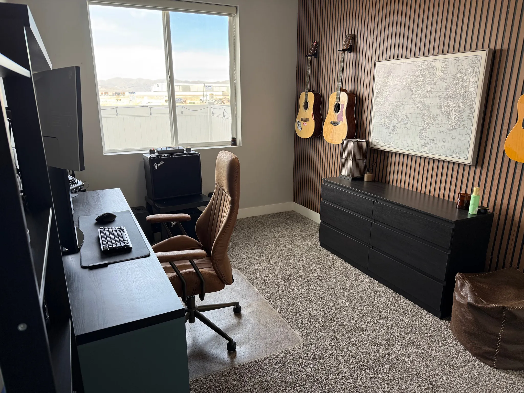 Office/bedroom area with light colored carpet and an accent wall