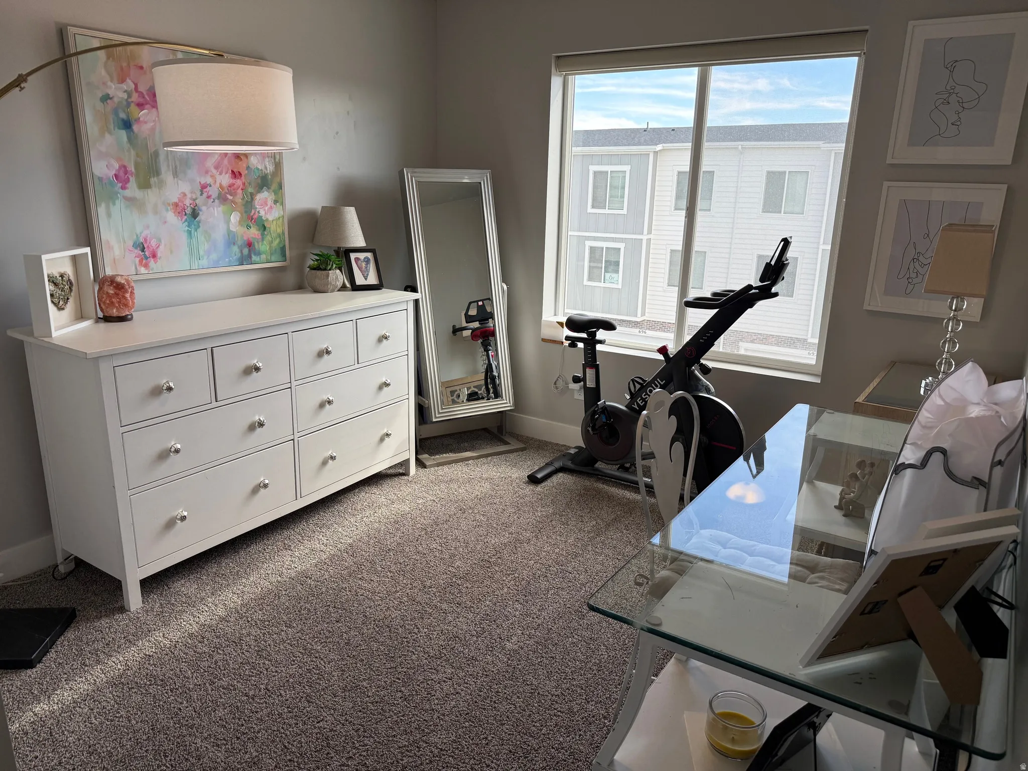 Bedroom featuring dark colored carpet and baseboards