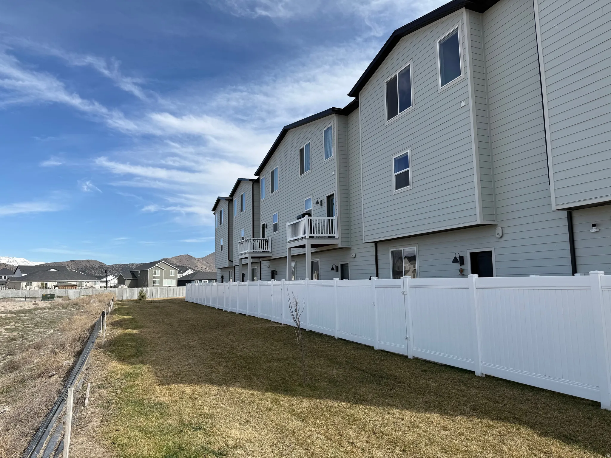 Fenced backyard with a mountain views