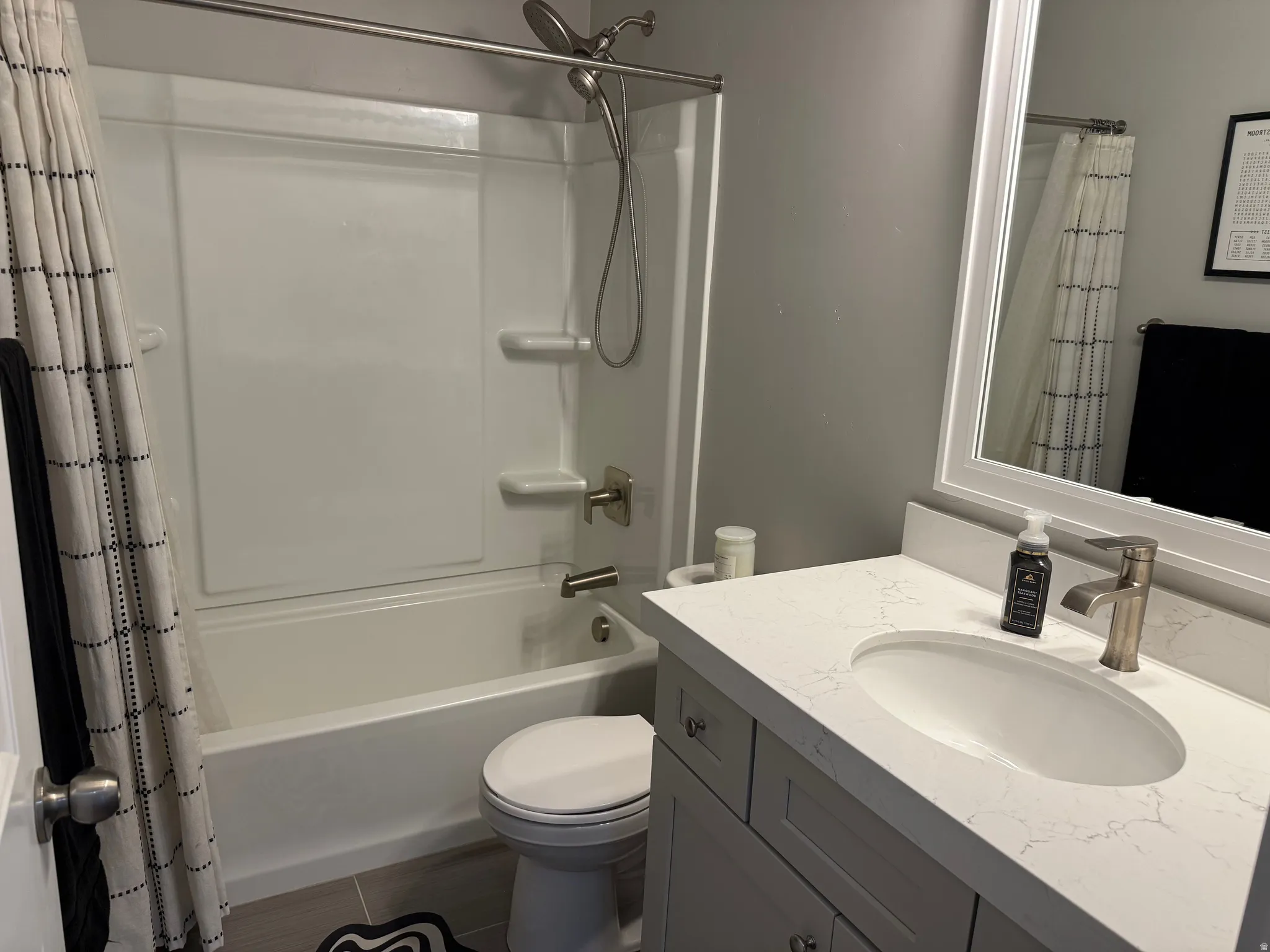 Full bath featuring vanity and shower / bath combo