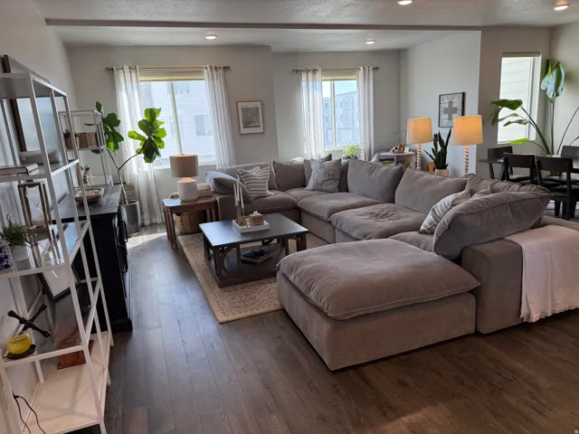 Oversized Living room with dark wood finished floors, recessed lighting, plenty of natural light, and a textured ceiling