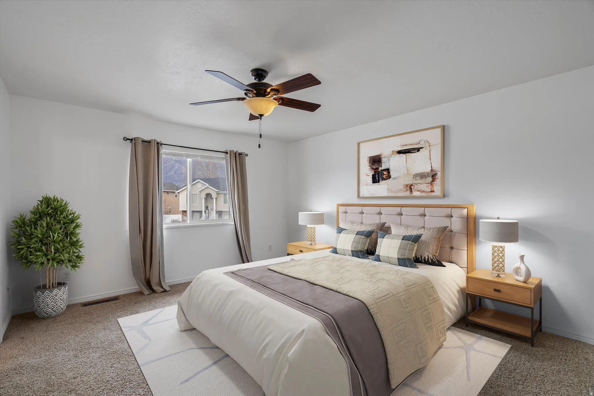 Bedroom featuring light carpet and a ceiling fan