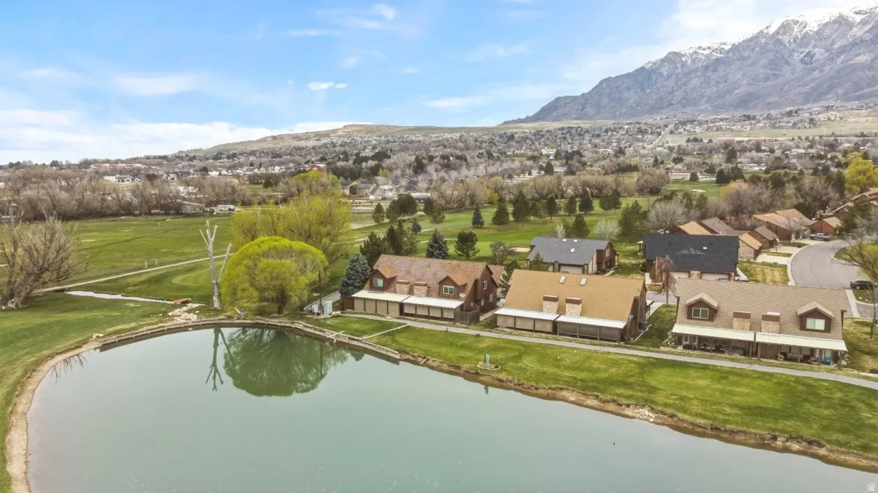 Aerial view of residential area with a water and mountain view and a local golf course