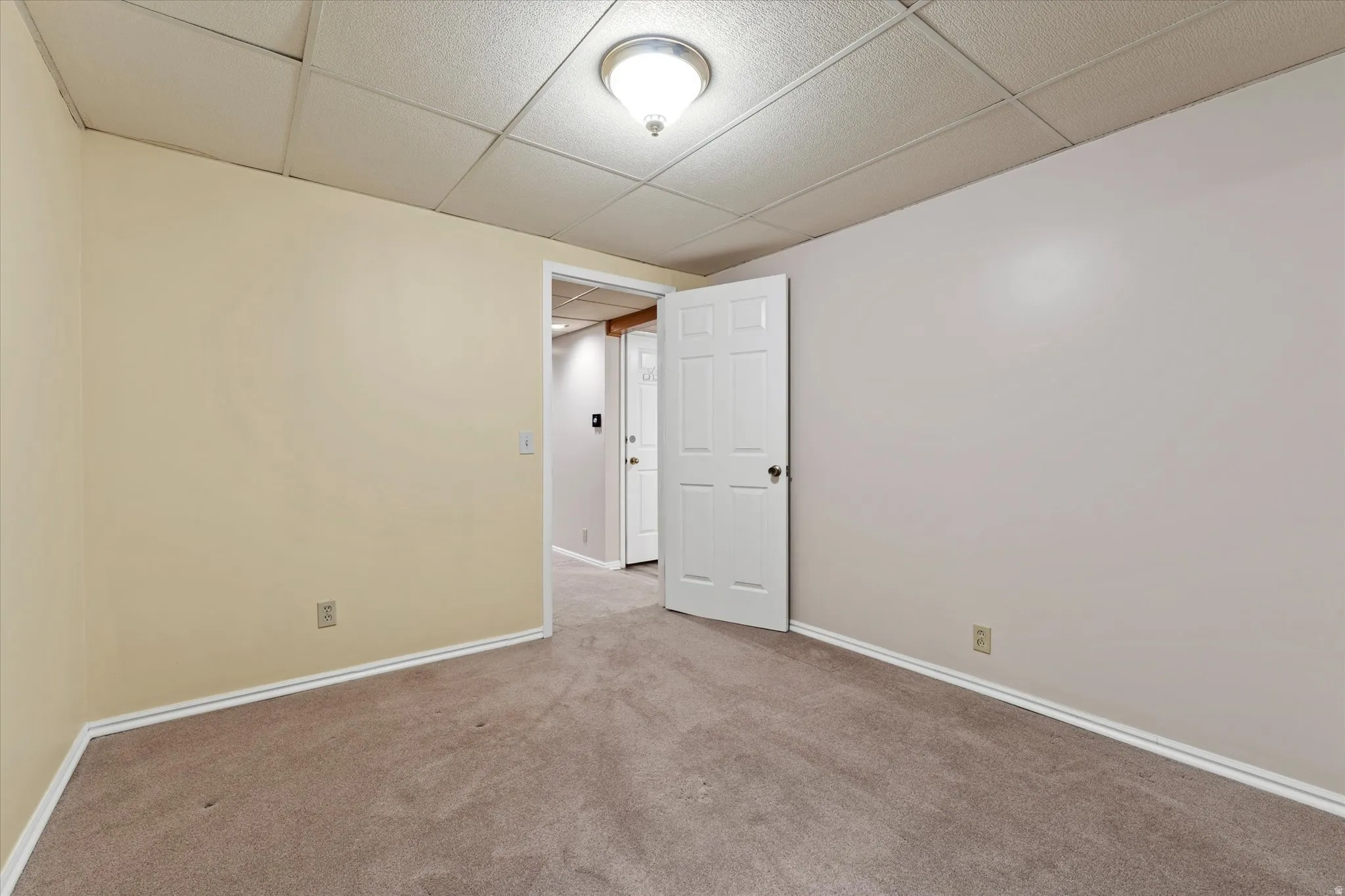 Versatile lower-level room with ample floor space, suitable for a bedroom, office, or hobby area.