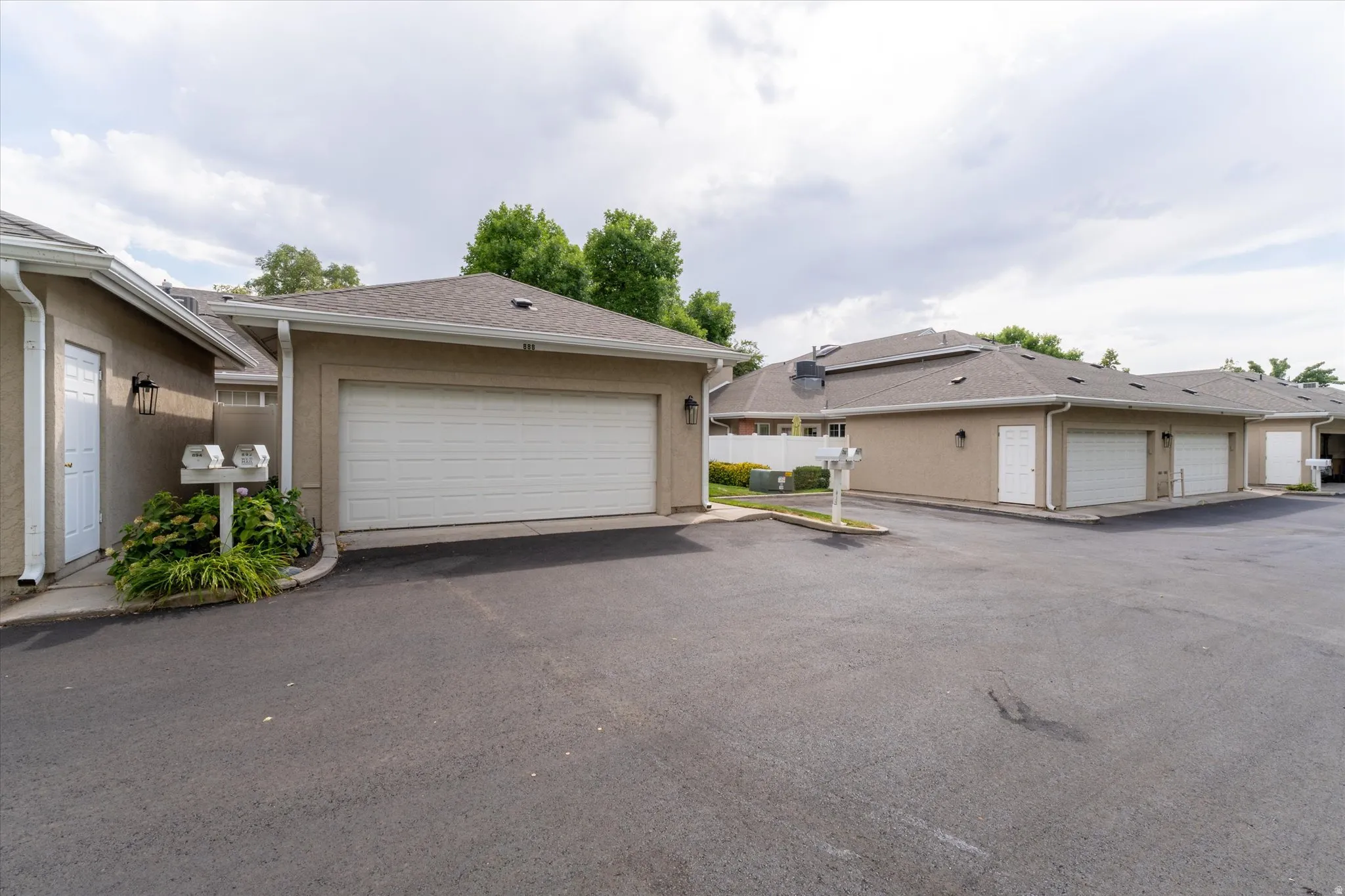 Spacious attached garage with convenient access and additional parking, providing practical storage and functionality.