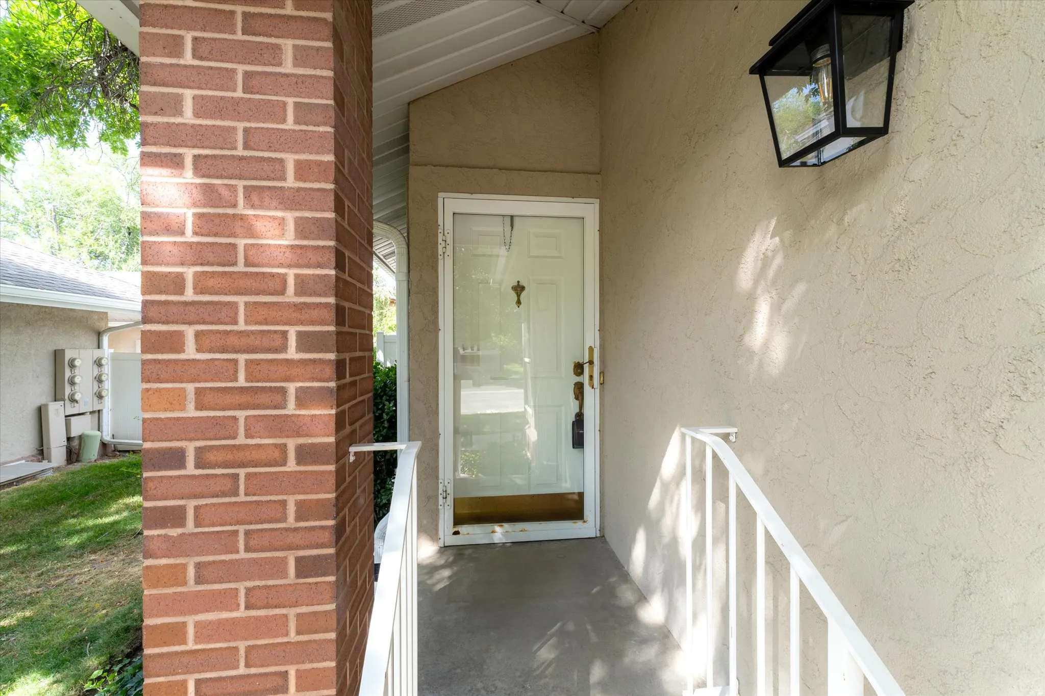 Property entrance featuring stucco siding