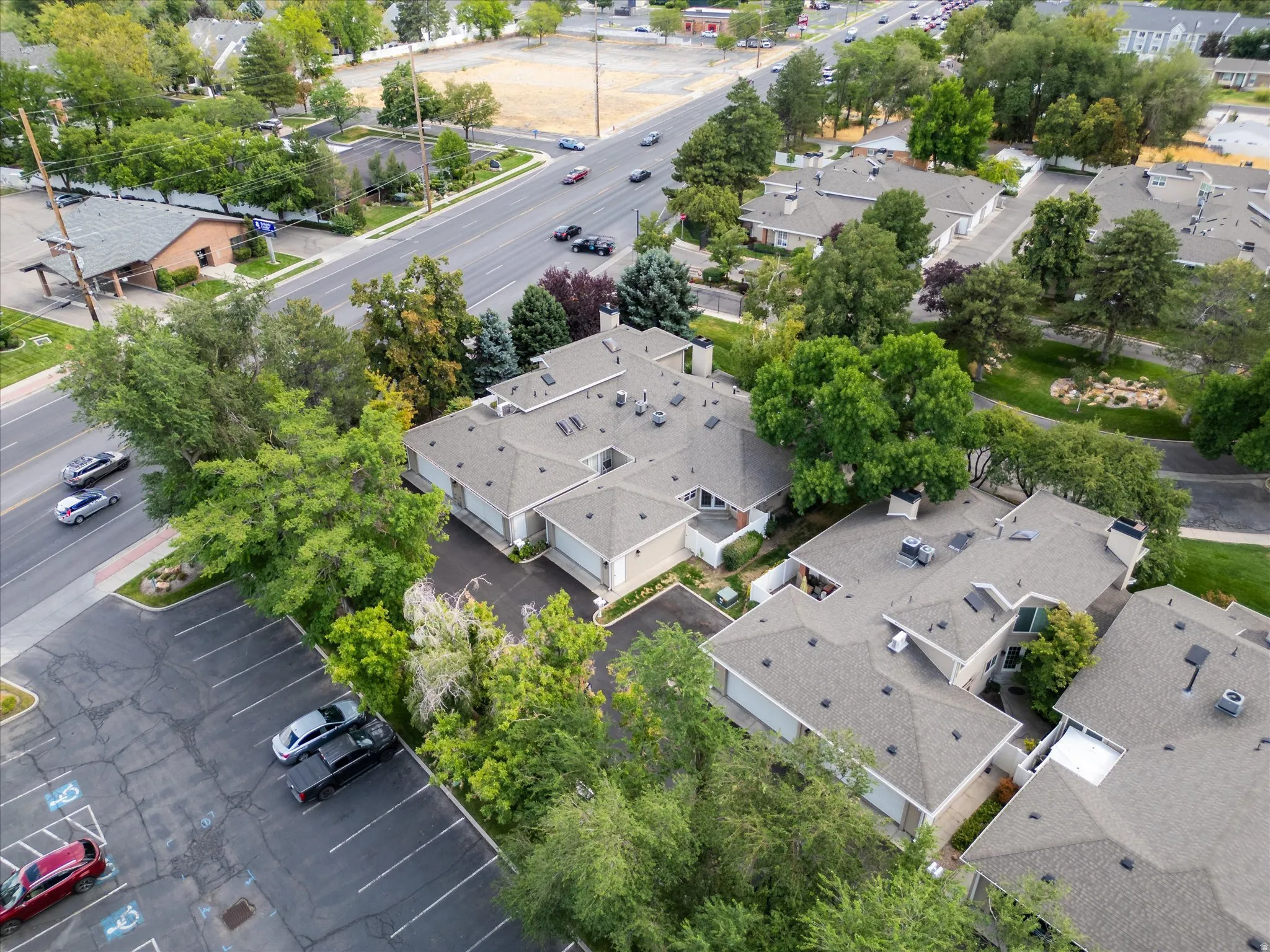 verhead view of the community showcasing mature trees, surrounding streets, and the well-maintained layout of the neighborhood.