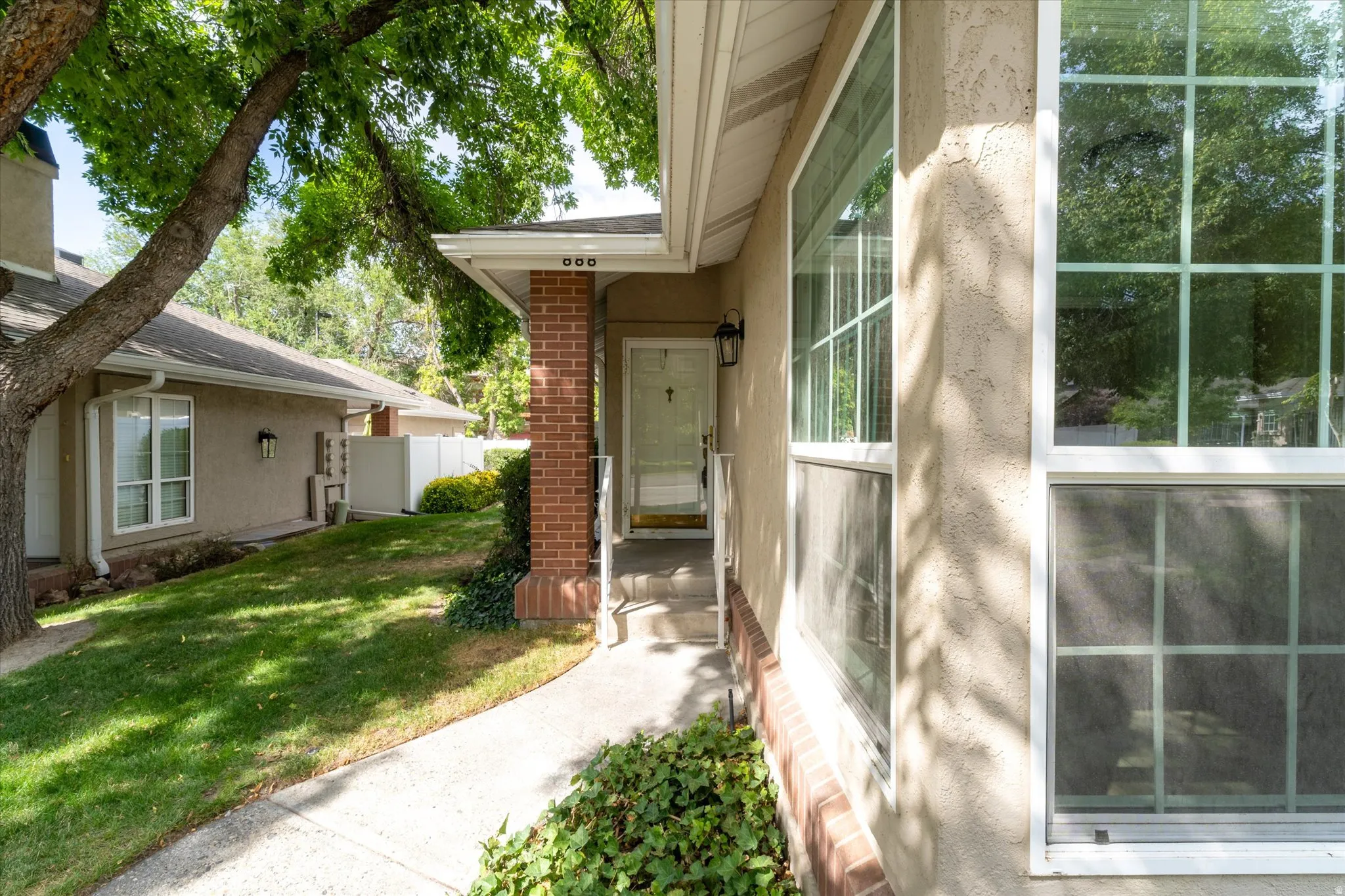 Private walkway leading to the front entrance with covered porch and welcoming curb appeal.