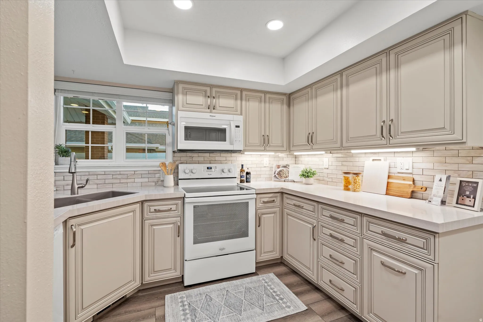 Efficient U-shaped layout with abundant cabinetry and workspace, complemented by modern lighting and a clean, cohesive design.