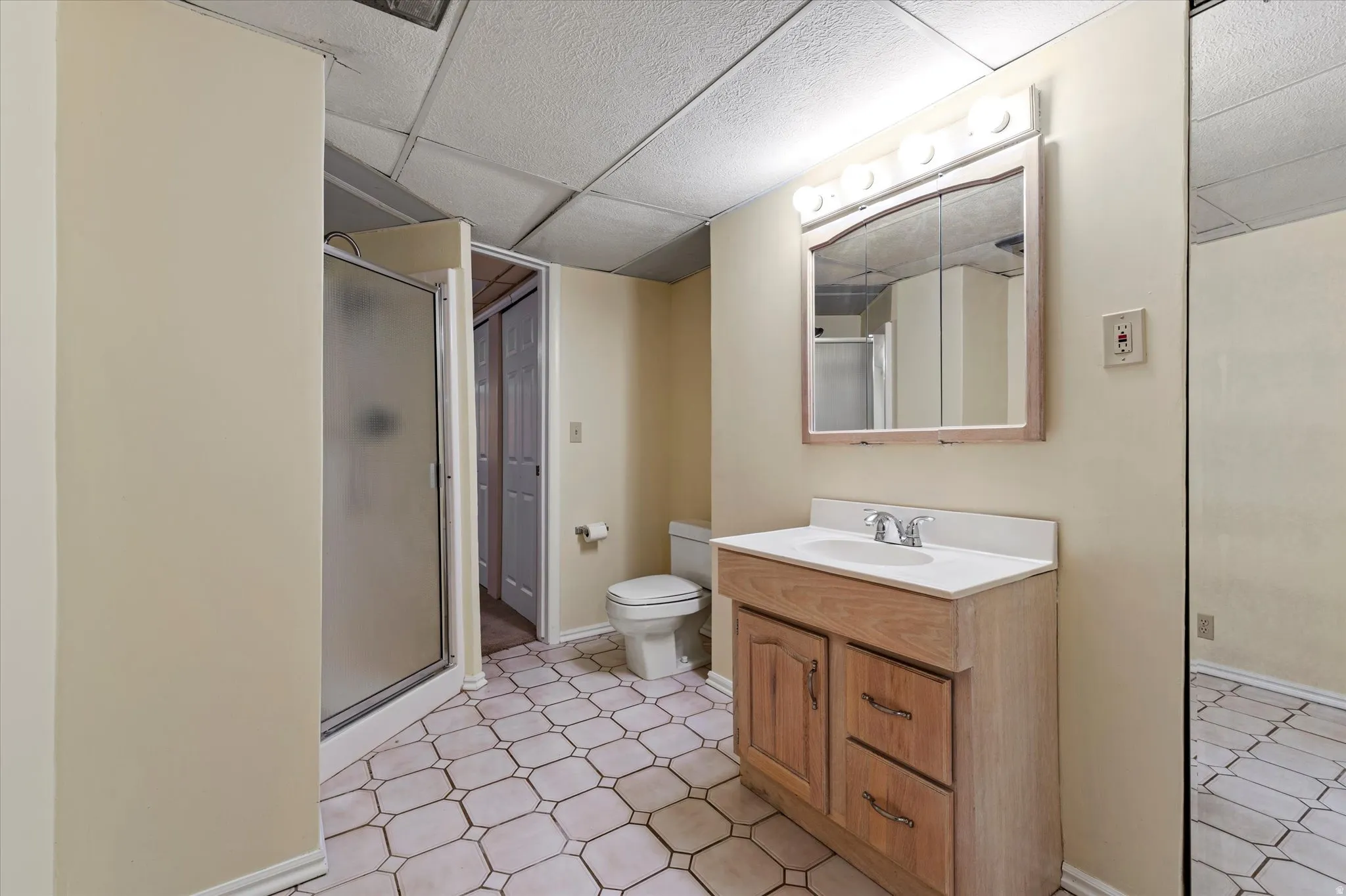Full bathroom featuring a walk-in shower, vanity, and functional layout for everyday convenience.