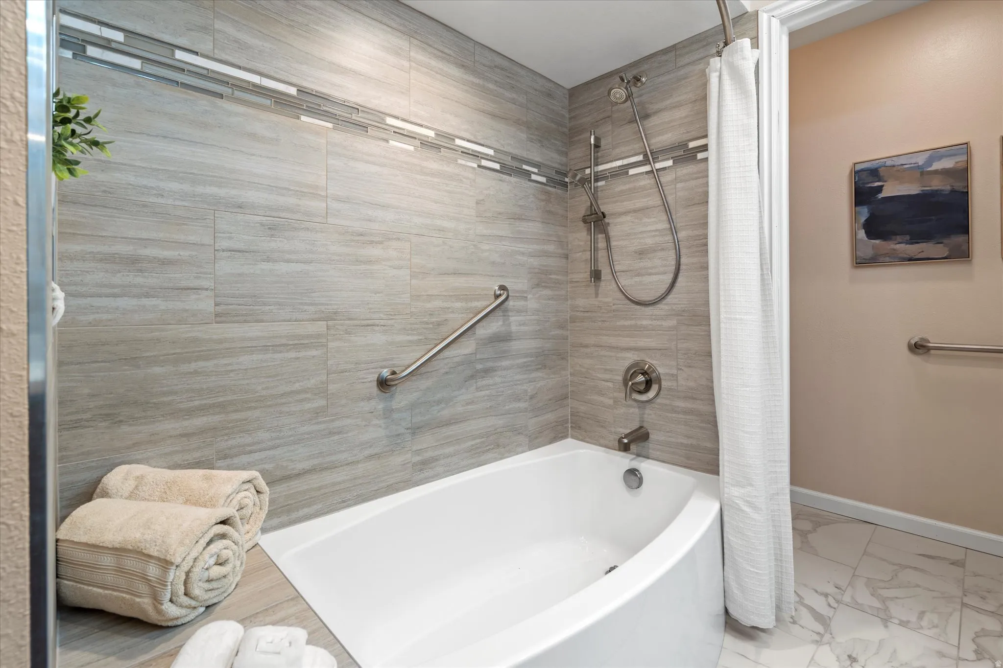 Stylish tub and shower combination with tile surround and contemporary finishes, offering a clean and functional space.