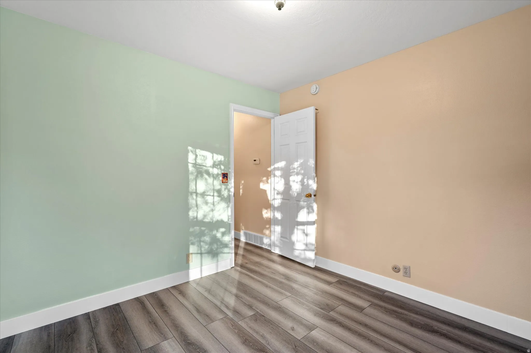 Versatile space with updated flooring, neutral tones, and easy access to adjacent areas of the home.