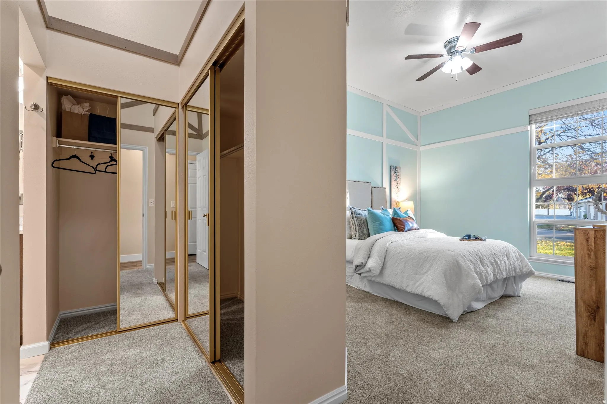 Spacious closet area with mirrored doors and ample hanging space, offering convenient organization just off the bedroom.