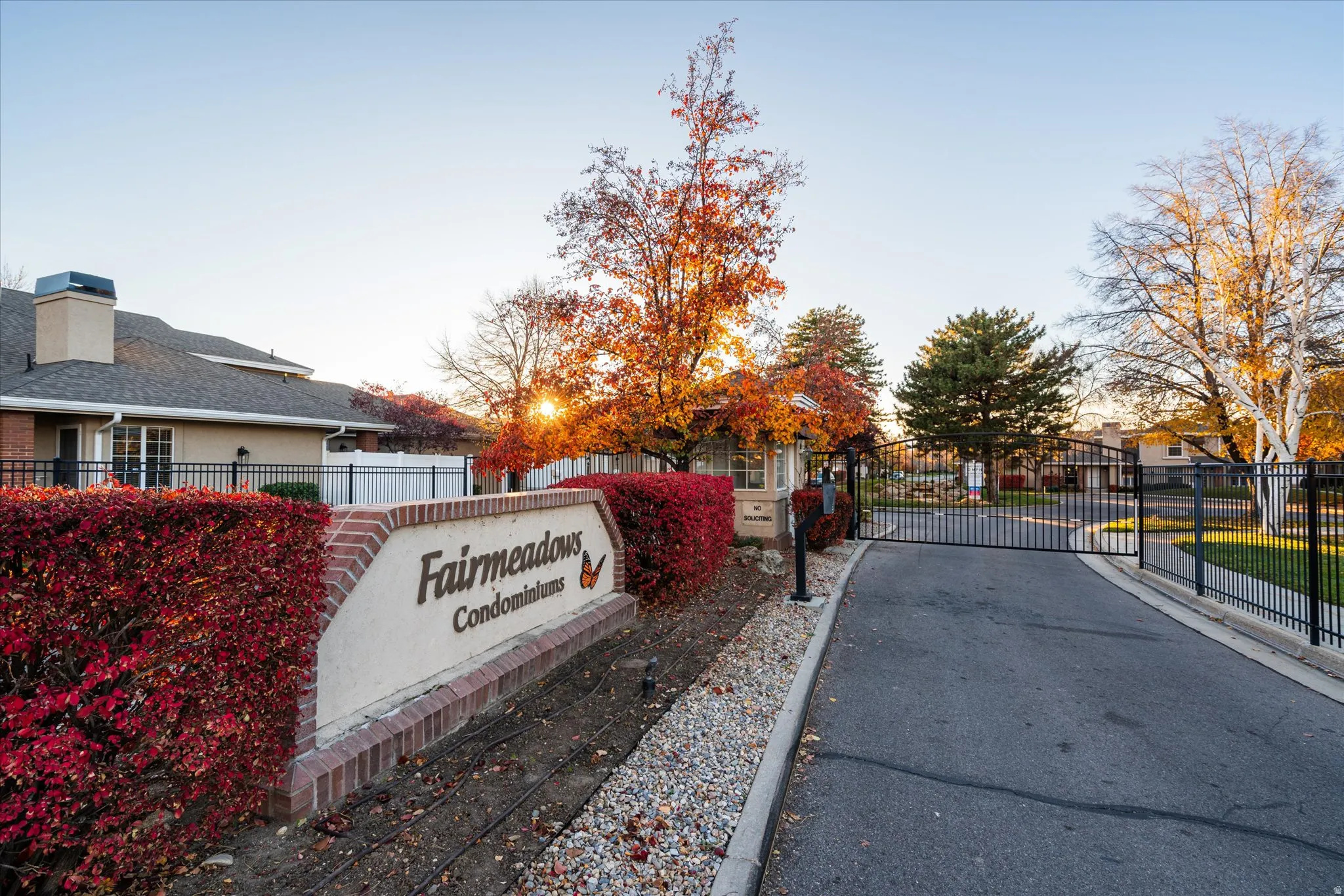 ated entry to Fairmeadows Condominiums with mature landscaping and well-maintained grounds, offering a welcoming first impression.