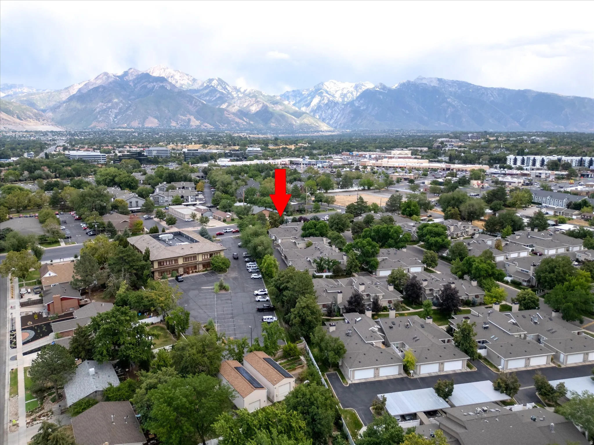 Scenic aerial capturing the home’s location with stunning mountain views in the distance, adding to the overall appeal of the area.