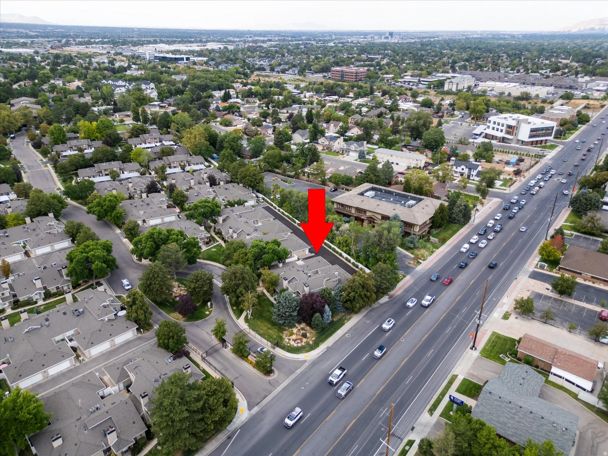 Bird’s-eye perspective of the well-maintained neighborhood featuring mature trees, organized layout, and close proximity to surrounding amenities.