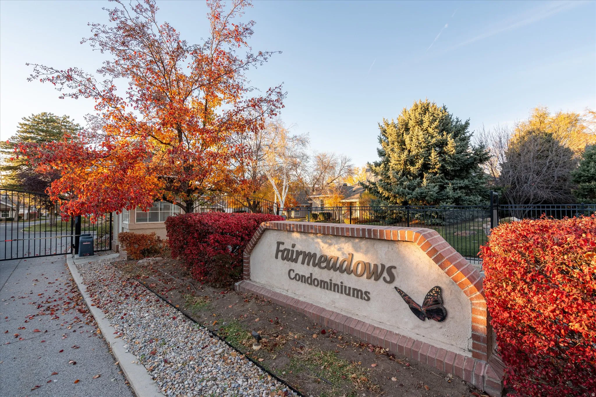Community / neighborhood sign featuring a gate