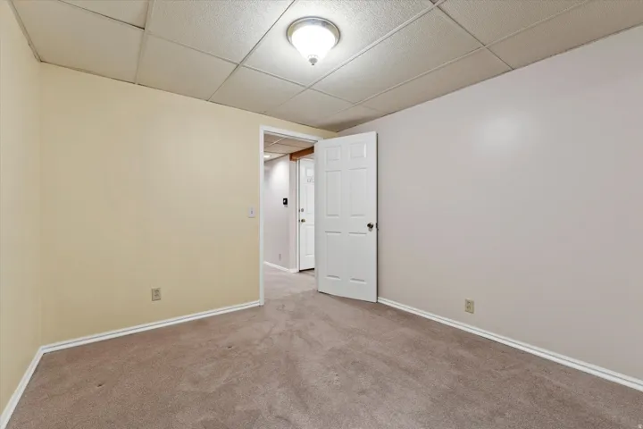 Versatile lower-level room with ample floor space, suitable for a bedroom, office, or hobby area.