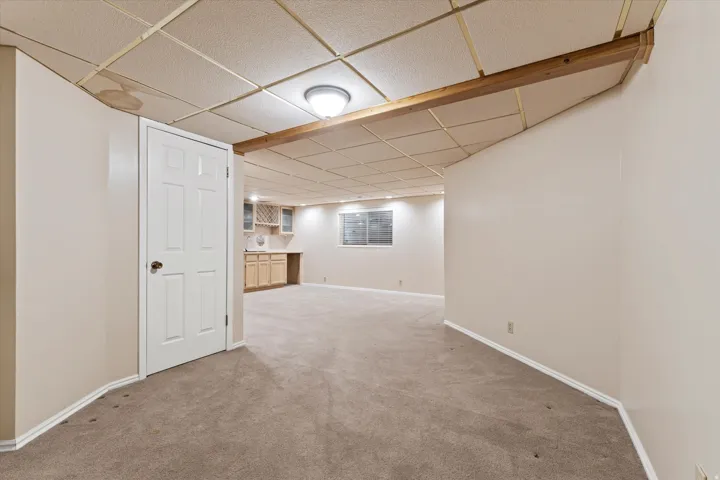 Flexible lower-level space with ample room for seating, hobbies, or guest accommodations.