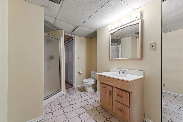 Full bathroom featuring a walk-in shower, vanity, and functional layout for everyday convenience.