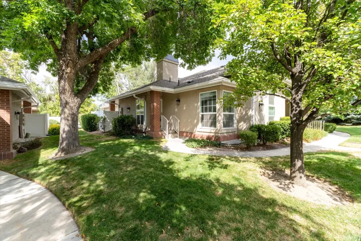 Exterior – Charming single-level exterior surrounded by mature trees and lush landscaping, offering shade, privacy, and a welcoming front entry with a peaceful, park-like setting.