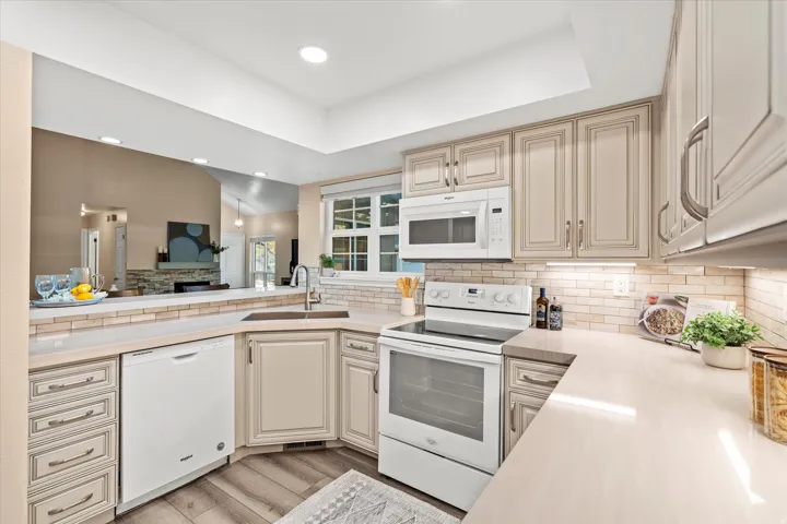 Well-appointed kitchen with generous counter space, updated finishes, and a convenient breakfast bar overlooking the main living area.