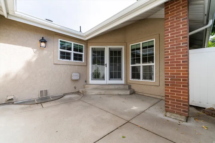 Enclosed patio space with concrete surface and surrounding privacy fencing, ideal for outdoor seating, dining, or low-maintenance enjoyment.