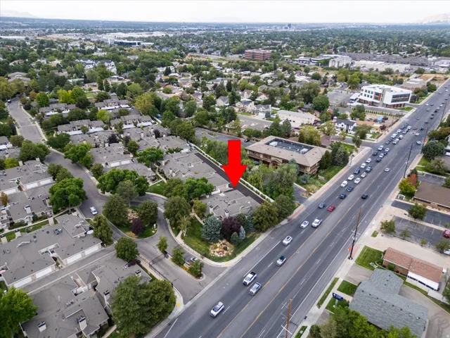 Bird’s-eye perspective of the well-maintained neighborhood featuring mature trees, organized layout, and close proximity to surrounding amenities.