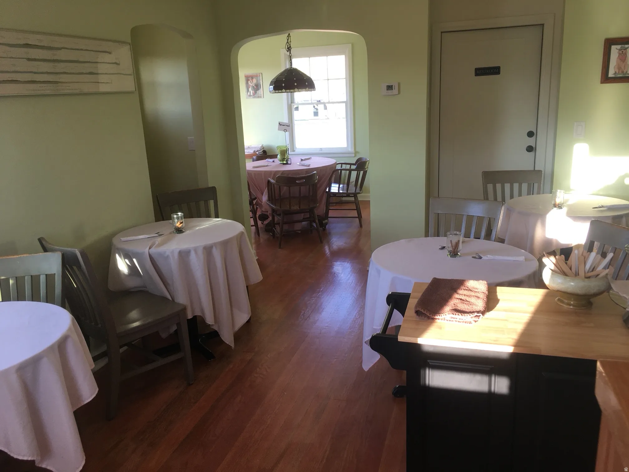 Dining room featuring arched walkways and wood finished floors