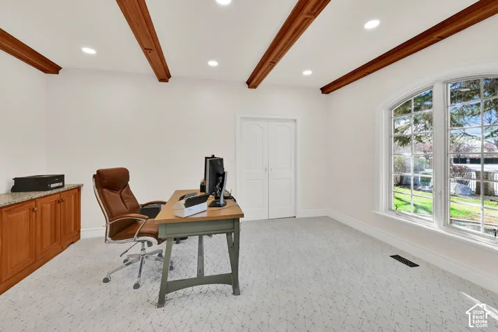 Office space with light carpet, beam ceiling, and recessed lighting