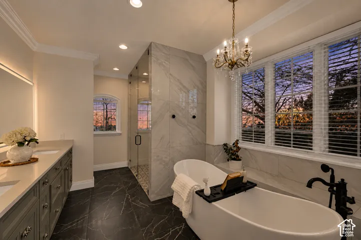 Freestanding soaking tub with a floor-mounted black faucet, set against large windows with white blinds